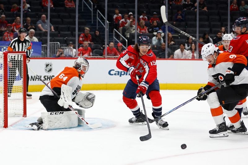 Sep 22, 2024; Washington, District of Columbia, USA; Washington Capitals forward Sonny Milano (15) and Philadelphia Flyers defenseman Jamie Drysdale (9) battle for the puck in front of Flyers goaltender Carson Bjarnason (64) in the third period at Capital One Arena. Mandatory Credit: Geoff Burke-Imagn Images