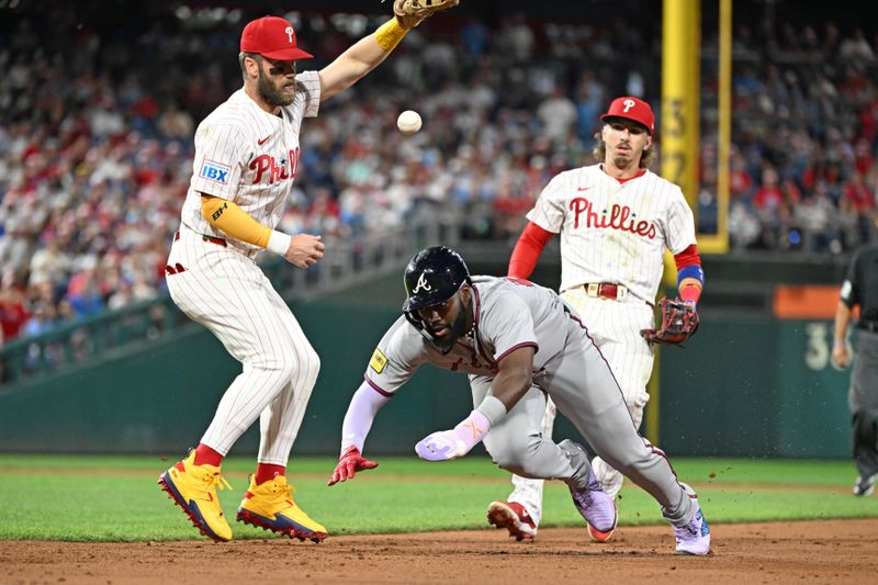 Aug 31, 2025; Philadelphia, Pennsylvania, USA;  Atlanta Braves outfielder Michael Harris II (23) dives safely back to first base as Philadelphia Phillies first base Bryce Harper (3) can't handle the throw from Philadelphia Phillies second base Bryson Stott (5) during the fifth inning at Citizens Bank Park. Mandatory Credit: Eric Hartline-Imagn Images