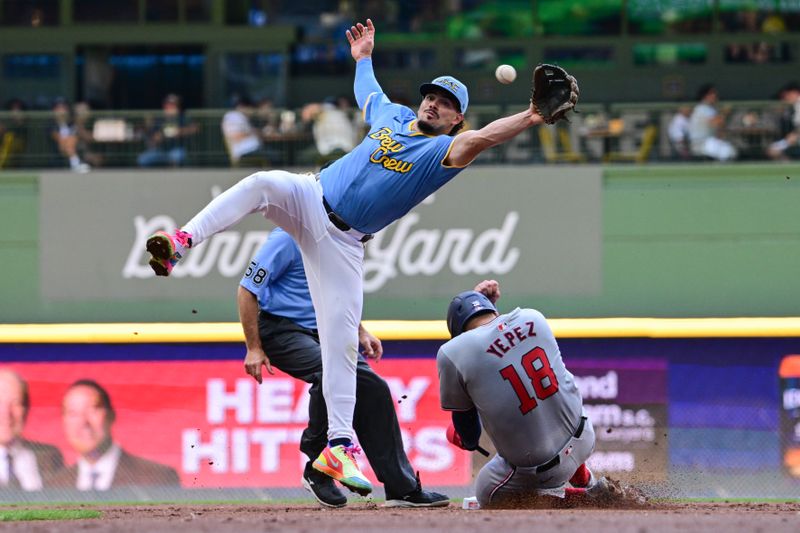 Jul 14, 2024; Milwaukee, Wisconsin, USA; Washington Nationals first baseman Juan Yepez (18) steals second base as Milwaukee Brewers shortstop Willy Adames (27) reaches for the ball in the second inning at American Family Field. Mandatory Credit: Benny Sieu-USA TODAY Sports