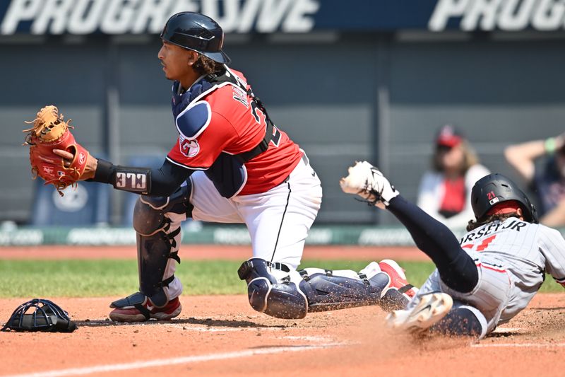 Aug 3, 2025; Cleveland, Ohio, USA; Minnesota Twins pinch runner DaShawn Keirsey Jr. (21) scores as Cleveland Guardians catcher Bo Naylor (23) waits for the throw during the eighth inning at Progressive Field. Mandatory Credit: Ken Blaze-Imagn Images