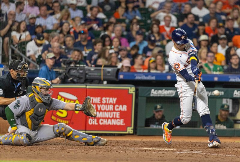 Sep 12, 2023; Houston, Texas, USA;Houston Astros center fielder Mauricio Dubon (14) hits a double against the Oakland Athletics in the seventh inning at Minute Maid Park. Mandatory Credit: Thomas Shea-USA TODAY Sports