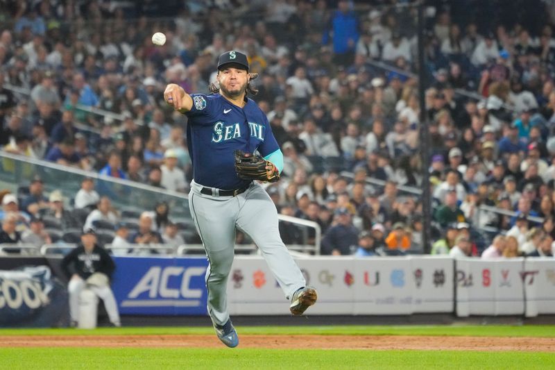 Jun 22, 2023; Bronx, New York, USA; Seattle Mariners third baseman Eugenio Suarez (28) throws out New York Yankees second baseman DJ LeMahieu (not pictured) after fielding a ground ball during the sixth inning at Yankee Stadium. Mandatory Credit: Gregory Fisher-USA TODAY Sports