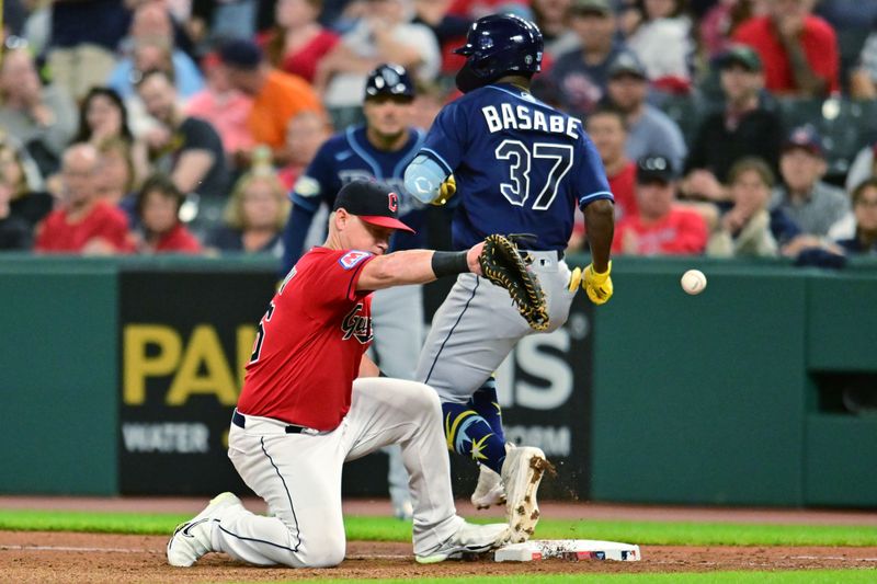 Sep 1, 2023; Cleveland, Ohio, USA; Tampa Bay Rays shortstop Osleivis Basabe (37) is safe at first base as Cleveland Guardians first baseman Kole Calhoun (56) can not handle the throw during the seventh inning at Progressive Field. Mandatory Credit: Ken Blaze-USA TODAY Sports