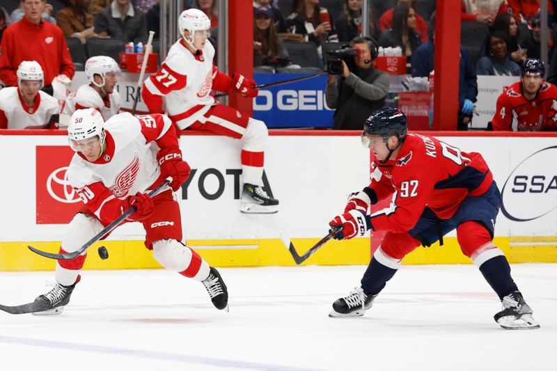 Sep 28, 2023; Washington, District of Columbia, USA; Detroit Red Wings forward Domink Shine (50) controls the puck as Washington Capitals center Evgeny Kuznetsov (92) defends in the second period at Capital One Arena. Mandatory Credit: Geoff Burke-USA TODAY Sports