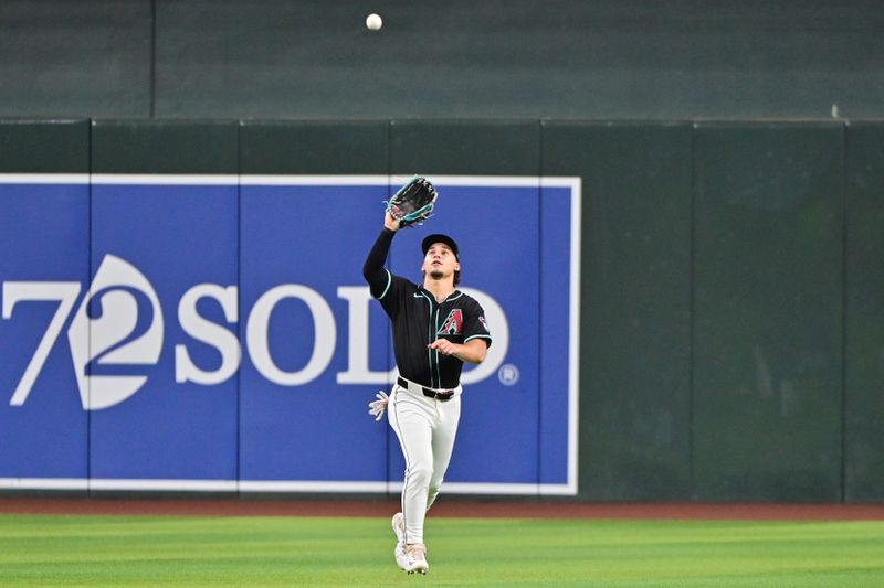 Jul 29, 2024; Phoenix, Arizona, USA;  Arizona Diamondbacks outfielder Alek Thomas (5) catches a fly ball in the second inning against the Washington Nationals at Chase Field. Mandatory Credit: Matt Kartozian-USA TODAY Sports