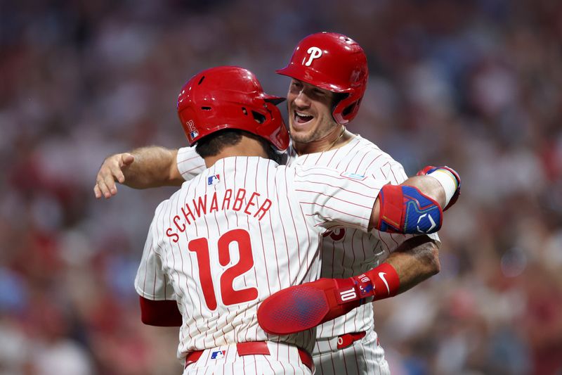 Aug 14, 2024; Philadelphia, Pennsylvania, USA; Philadelphia Phillies designated hitter Kyle Schwarber (12) celebrates with catcher J.T. Realmuto (10) after hitting a four RBI grand slam during the fourth inning against the Miami Marlins at Citizens Bank Park. Mandatory Credit: Bill Streicher-USA TODAY Sports