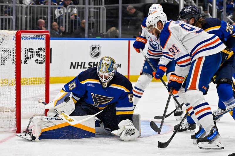 Feb 15, 2024; St. Louis, Missouri, USA;  St. Louis Blues goaltender Jordan Binnington (50) defends the net against Edmonton Oilers left wing Evander Kane (91) during the third period at Enterprise Center. Mandatory Credit: Jeff Curry-USA TODAY Sports