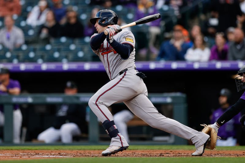Apr 28, 2025; Denver, Colorado, USA; Atlanta Braves third baseman Austin Riley (27) hits a single in the third inning against the Colorado Rockies at Coors Field. Mandatory Credit: Isaiah J. Downing-Imagn Images