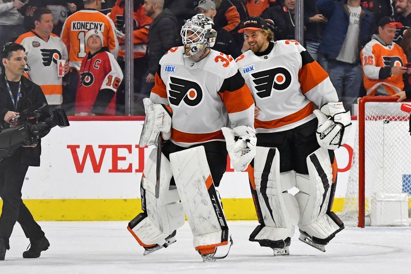 Mar 2, 2024; Philadelphia, Pennsylvania, USA; Philadelphia Flyers goaltender Felix Sandstrom (32) and goaltender Samuel Ersson (33) celebrate win against the Ottawa Senators at Wells Fargo Center. Mandatory Credit: Eric Hartline-USA TODAY Sports