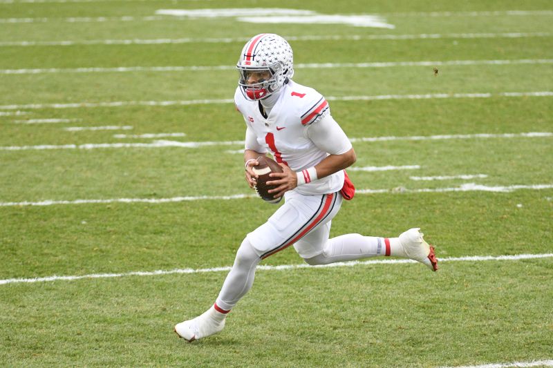 Dec 5, 2020; East Lansing, Michigan, USA; Ohio State Buckeyes quarterback Justin Fields (1) runs the ball for a touchdown during the first quarter against the Michigan State Spartans at Spartan Stadium. Mandatory Credit: Tim Fuller-USA TODAY Sports