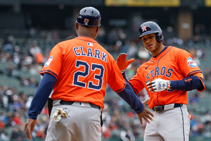 May 4, 2025; Chicago, Illinois, USA; Houston Astros shortstop Jeremy Pena (3) celebrates with first base coach Dave Clark (23) after hitting a single against the Chicago White Sox during the fourth inning at Rate Field. Mandatory Credit: Kamil Krzaczynski-Imagn Images