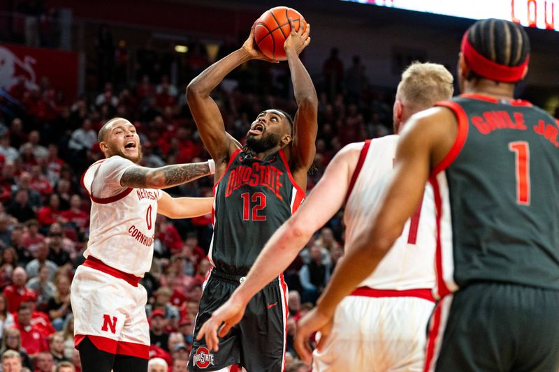 Jan 23, 2024; Lincoln, Nebraska, USA; Ohio State Buckeyes guard Evan Mahaffey (12) shoots the ball against Nebraska Cornhuskers guard C.J. Wilcher (0), guard Eli Rice (11) and forward Rienk Mast (51) during the second half at Pinnacle Bank Arena. Mandatory Credit: Dylan Widger-USA TODAY Sports