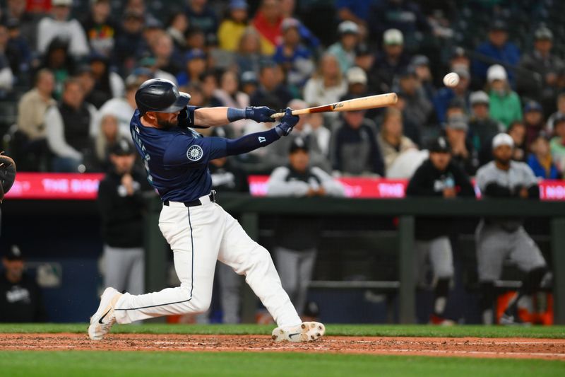 Jun 12, 2024; Seattle, Washington, USA; Seattle Mariners pinch hitter Mitch Haniger (17) hits a walk-off single against the Chicago White Sox during the tenth inning at T-Mobile Park. Mandatory Credit: Steven Bisig-USA TODAY Sports