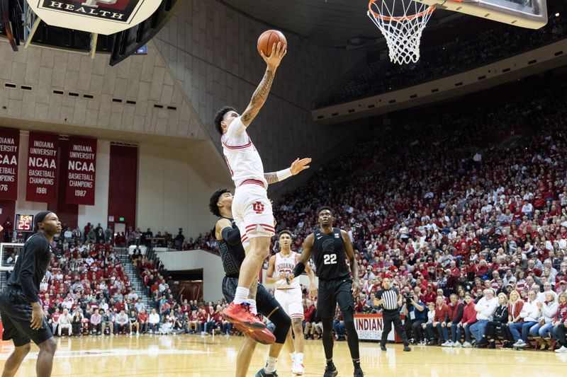 Jan 22, 2023; Bloomington, Indiana, USA; Indiana Hoosiers guard Jalen Hood-Schifino (1) shoots the ball while Michigan State Spartans guard A.J. Hoggard (11) defends in the first half at Simon Skjodt Assembly Hall. Mandatory Credit: Trevor Ruszkowski-USA TODAY Sports