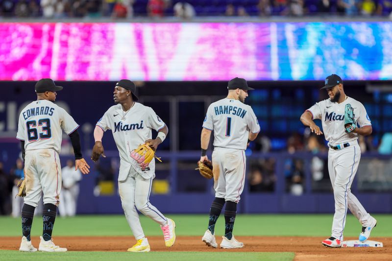 Sep 24, 2023; Miami, Florida, USA; Miami Marlins shortstop Xavier Edwards (63), center fielder Jazz Chisholm Jr. (2), third baseman Garrett Hampson (1), and left fielder Bryan De La Cruz (14) celebrate after winning the game against the Milwaukee Brewers at loanDepot Park. Mandatory Credit: Sam Navarro-USA TODAY Sports