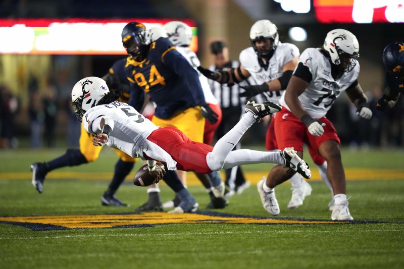 Nov 18, 2023; Morgantown, West Virginia, USA; Cincinnati Bearcats quarterback Emory Jones (5) is penalized for intentional grounding against the West Virginia Mountaineers in the fourth quarter at Milan Puskar Stadium. West Virginia won 42-21. Mandatory Credit: Kareem Elgazzar-USA TODAY Sports