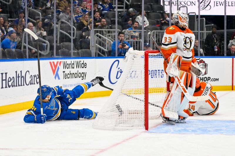 Dec 1, 2025; St. Louis, Missouri, USA; Anaheim Ducks defenseman Drew Helleson (14) gets his stick caught in the skate of St. Louis Blues left wing Dylan Holloway (81) during the second period at Enterprise Center. Mandatory Credit: Jeff Curry-Imagn Images
