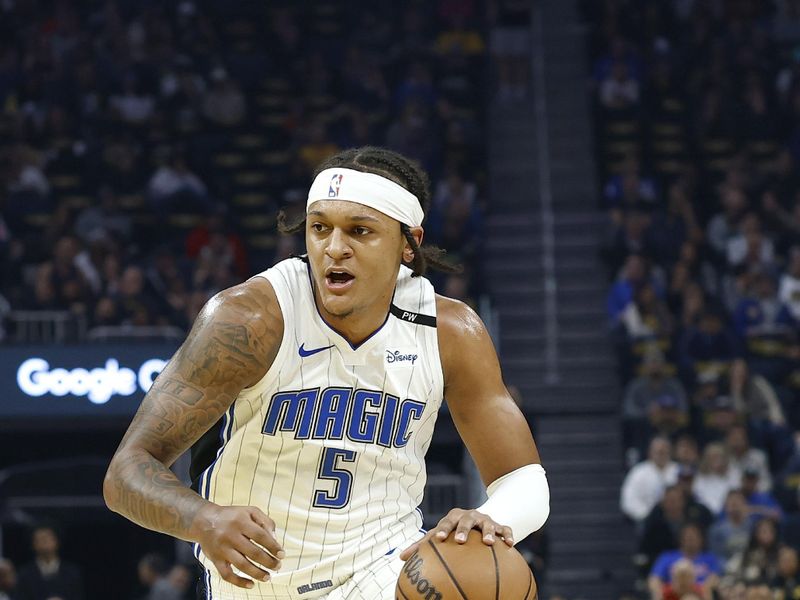 SAN FRANCISCO, CALIFORNIA - FEBRUARY 03: Paolo Banchero #5 of the Orlando Magic dribbles the ball against the Golden State Warriors during the first half of an NBA basketball game at Chase Center on February 03, 2025 in San Francisco, California. NOTE TO USER: User expressly acknowledges and agrees that, by downloading and or using this photograph, User is consenting to the terms and conditions of the Getty Images License Agreement.  (Photo by Thearon W. Henderson/Getty Images)