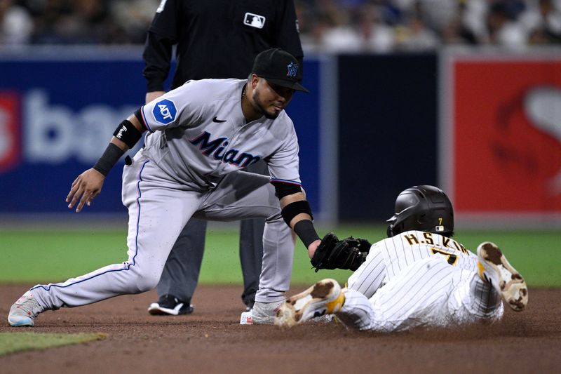 Aug 22, 2023; San Diego, California, USA; San Diego Padres third baseman Ha-seong Kim (7) is caught stealing by Miami Marlins second baseman Luis Arraez (3) during the sixth inning at Petco Park. Mandatory Credit: Orlando Ramirez-USA TODAY Sports