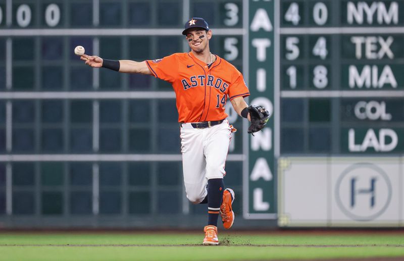 May 31, 2024; Houston, Texas, USA; Houston Astros shortstop Mauricio Dubon (14) throws out a runner at first base during the first inning against the Minnesota Twins at Minute Maid Park. Mandatory Credit: Troy Taormina-USA TODAY Sports