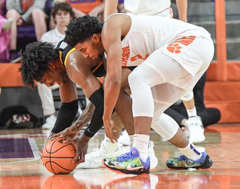 Feb 27, 2024; Clemson, South Carolina, USA;  Clemson sophomore guard Dillon Hunter (2) and Pitt forward Blake Hinson (2) reach for a loose ball during the first half at Littlejohn Coliseum. Mandatory Credit: Ken Ruinard-USA TODAY Sports