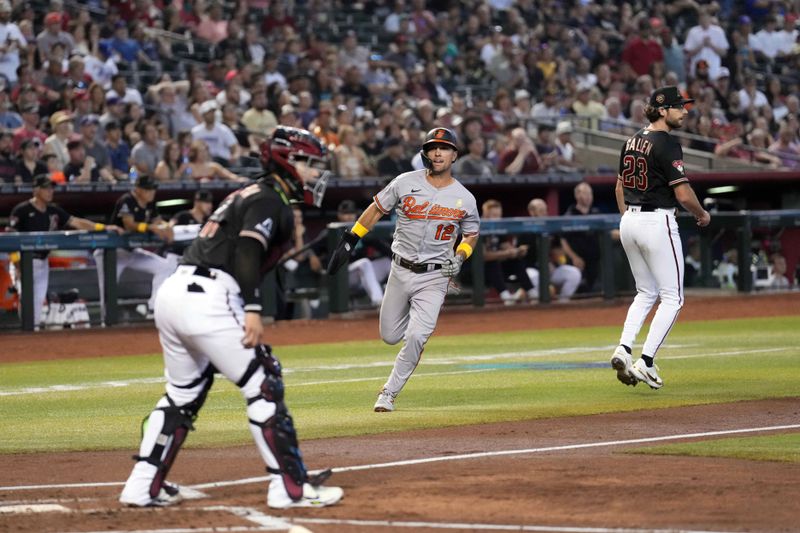 Sep 3, 2023; Phoenix, Arizona, USA; Baltimore Orioles second baseman Adam Frazier (12) scores a run against the Arizona Diamondbacks during the first inning at Chase Field. Mandatory Credit: Joe Camporeale-USA TODAY Sports