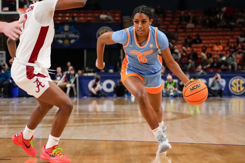 Mar 8, 2024; Greensville, SC, USA; Tennessee Lady Vols guard Kaiya Wynn (5) dribbles against Alabama Crimson Tide guard Loyal McQueen (0) during the second half at Bon Secours Wellness Arena. Mandatory Credit: Jim Dedmon-USA TODAY Sports