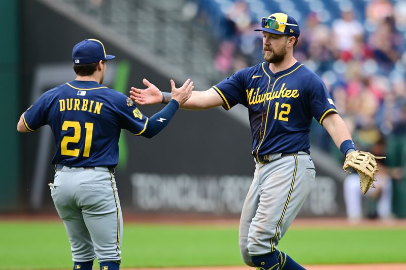 May 14, 2025; Cleveland, Ohio, USA; Milwaukee Brewers third baseman Caleb Durbin (21) and first baseman Rhys Hoskins (12) celebrate after the Brewers beat the Cleveland Guardians at Progressive Field. Mandatory Credit: Ken Blaze-Imagn Images