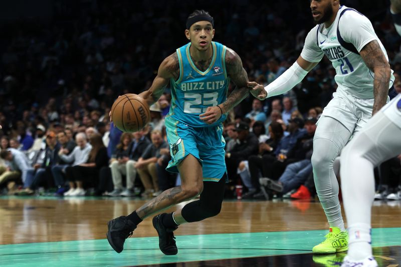 CHARLOTTE, NORTH CAROLINA - APRIL 09: Tre Mann #23 of the Charlotte Hornets controls the ball during the first half of an NBA game against the Dallas Mavericks at Spectrum Center on April 09, 2024 in Charlotte, North Carolina. NOTE TO USER: User expressly acknowledges and agrees that, by downloading and or using this photograph, User is consenting to the terms and conditions of the Getty Images License Agreement. (Photo by David Jensen/Getty Images)