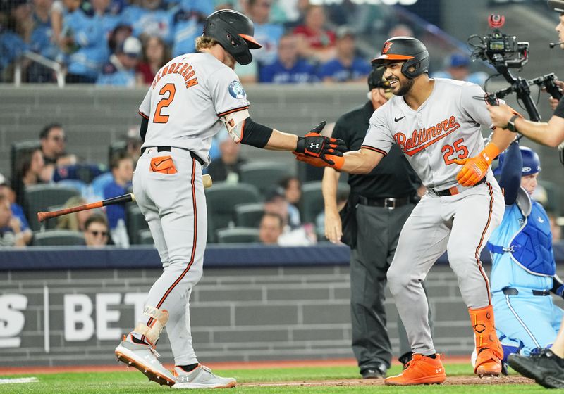 Aug 7, 2024; Toronto, Ontario, CAN; Baltimore Orioles right fielder Anthony Santander (25) hits a home run and celebrates with Baltimore Orioles shortstop Gunnar Henderson (2) against the Toronto Blue Jays during the eighth inning at Rogers Centre. Mandatory Credit: Nick Turchiaro-USA TODAY Sports
