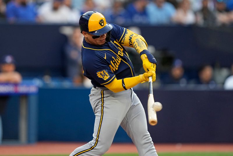 May 30, 2023; Toronto, Ontario, CAN; Milwaukee Brewers catcher William Contreras (24) hits a two run home run during the first inning against the Toronto Blue Jays at Rogers Centre. Mandatory Credit: John E. Sokolowski-USA TODAY Sports