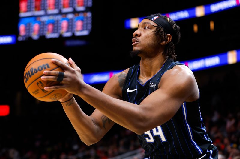 ATLANTA, GEORGIA - JANUARY 17: Wendell Carter Jr. #34 of the Orlando Magic shoots during the first quarter against the Atlanta Hawks at State Farm Arena on January 17, 2024 in Atlanta, Georgia. NOTE TO USER: User expressly acknowledges and agrees that, by downloading and or using this photograph, User is consenting to the terms and conditions of the Getty Images License Agreement. (Photo by Todd Kirkland/Getty Images)