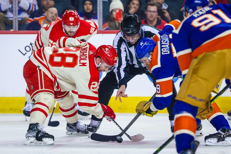 Jan 20, 2024; Calgary, Alberta, CAN; Calgary Flames center Elias Lindholm (28) and Edmonton Oilers center Leon Draisaitl (29) face off for the puck during the first period at Scotiabank Saddledome. Mandatory Credit: Sergei Belski-USA TODAY Sports