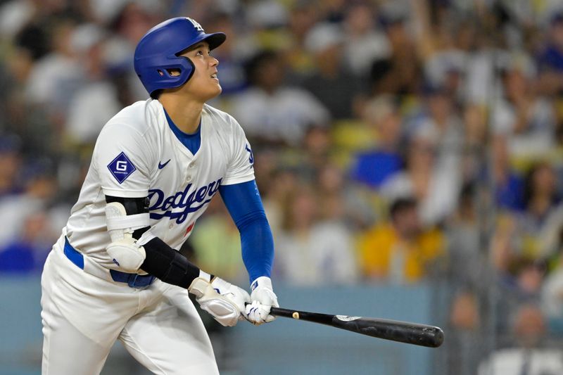 Sep 6, 2024; Los Angeles, California, USA;  Los Angeles Dodgers designated hitter Shohei Ohtani (17) watches the flight of the ball on his 45th home run on the season in the sixth inning against the Cleveland Guardians at Dodger Stadium. Mandatory Credit: Jayne Kamin-Oncea-Imagn Images