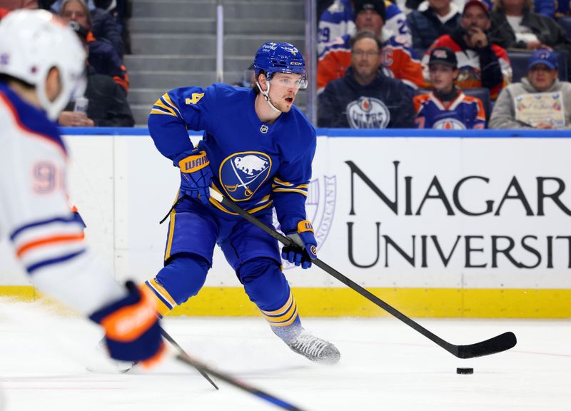 Nov 17, 2025; Buffalo, New York, USA;  Buffalo Sabres defenseman Bowen Byram (4) looks to make a pass during the second period against the Edmonton Oilers at KeyBank Center. Mandatory Credit: Timothy T. Ludwig-Imagn Images