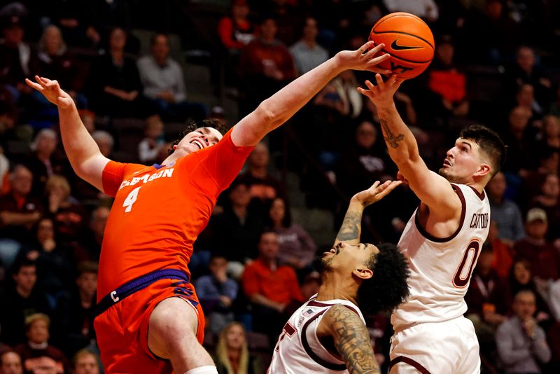 Jan 10, 2024; Blacksburg, Virginia, USA; Clemson Tigers forward Ian Schieffelin (4) goes for rebound against Virginia Tech Hokies guard Hunter Cattoor (0) during the first half at Cassell Coliseum. Mandatory Credit: Peter Casey-USA TODAY Sports