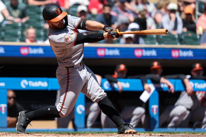 May 8, 2025; Minneapolis, Minnesota, USA; Baltimore Orioles catcher Maverick Handley (98) hits his first career base hit against the Minnesota Twins during the fourth inning at Target Field. Mandatory Credit: Matt Krohn-Imagn Images