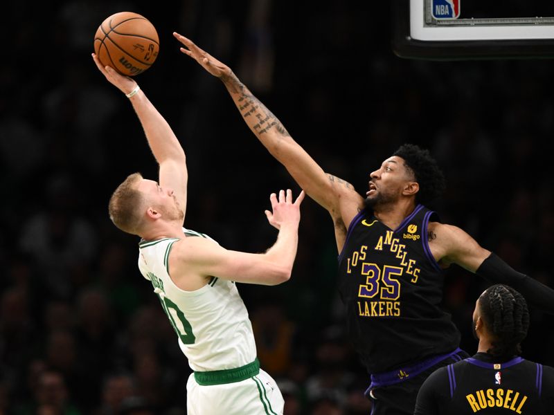 BOSTON, MASSACHUSETTS - FEBRUARY 01: Christian Wood #35 of the Los Angeles Lakers defends Sam Hauser #30 of the Boston Celtics during the second quarter at the TD Garden on February 01, 2024 in Boston, Massachusetts. NOTE TO USER: User expressly acknowledges and agrees that, by downloading and or using this photograph, User is consenting to the terms and conditions of the Getty Images License Agreement. (Photo by Brian Fluharty/Getty Images)