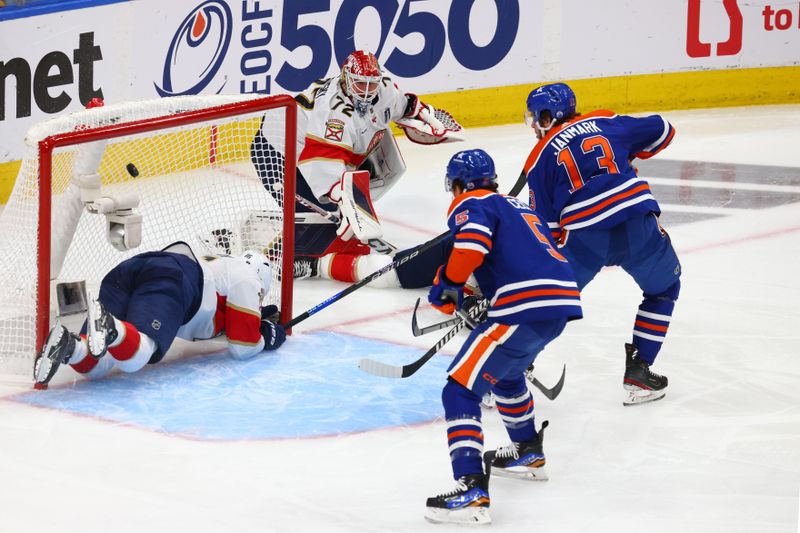 Jun 15, 2024; Edmonton, Alberta, CAN; Edmonton Oilers center Mattias Janmark (13) scores a goal passed Florida Panthers center Aleksander Barkov (16) in the first period in game four of the 2024 Stanley Cup Final at Rogers Place. Mandatory Credit: Sergei Belski-USA TODAY Sports