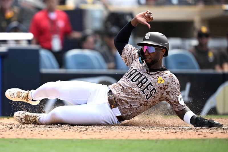 Jun 23, 2024; San Diego, California, USA; San Diego Padres left fielder Jurickson Profar (10) slides home to score a run against the Milwaukee Brewers during the eighth inning at Petco Park. Mandatory Credit: Orlando Ramirez-USA TODAY Sports