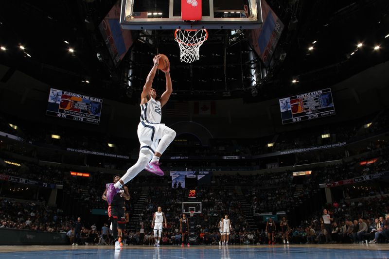 MEMPHIS, TN - OCTOBER 18: Desmond Bane #22 of the Memphis Grizzlies dunks the ball during the game against the Miami Heat during a NBA pre season game on October 18, 2024 at FedExForum in Memphis, Tennessee. NOTE TO USER: User expressly acknowledges and agrees that, by downloading and or using this photograph, User is consenting to the terms and conditions of the Getty Images License Agreement. Mandatory Copyright Notice: Copyright 2024 NBAE (Photo by Joe Murphy/NBAE via Getty Images)