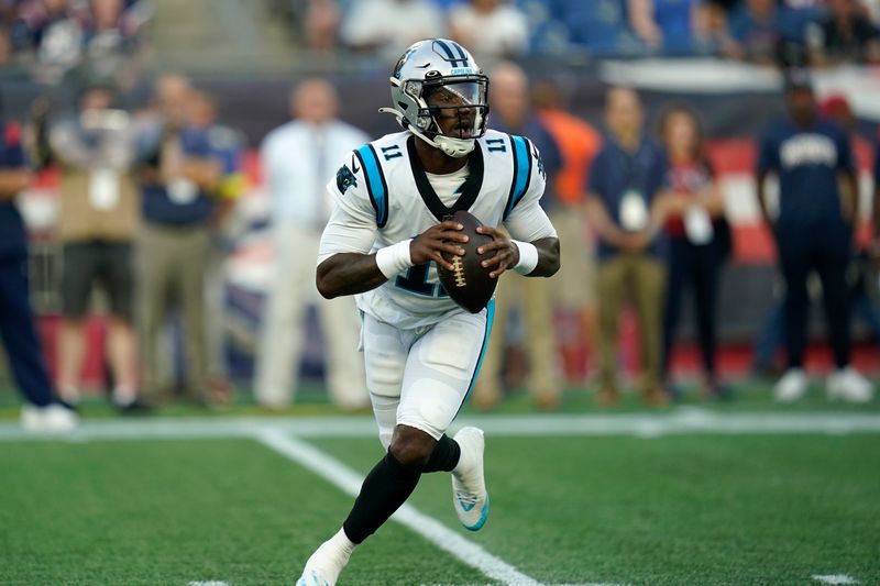 Carolina Panthers quarterback PJ Walker (11) runs with the ball in the first half of a preseason NFL football game against the New England Patriots, Friday, Aug. 19, 2022, in Foxborough, Mass. (AP Photo/Charles Krupa)