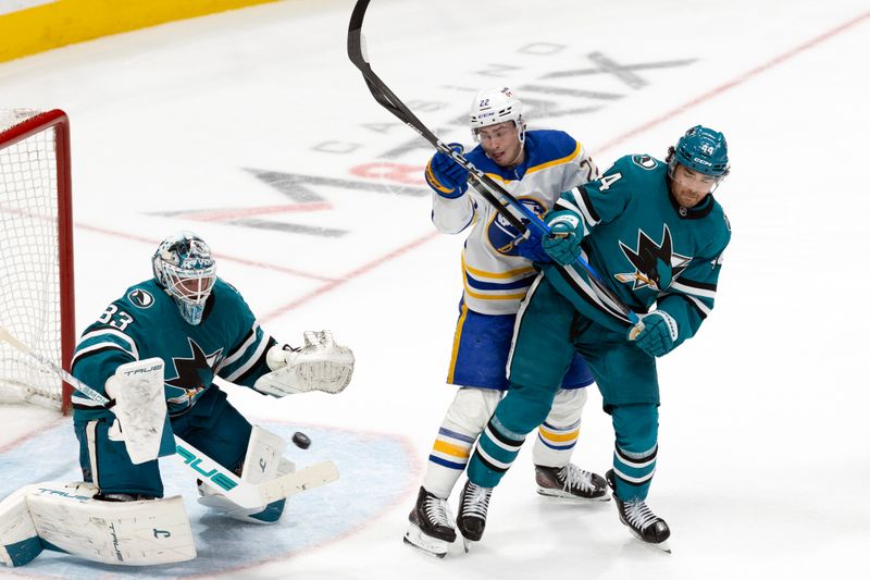 Mar 19, 2026; San Jose, California, USA; San Jose Sharks goaltender Alex Nedelijkovic (33) saves a shot on goal as Buffalo Sabres right wing Jack Quinn (22) and San Jose Sharks left wing Kiefer Sherwood (44) jockey for position during the third period at SAP Center at San Jose. Mandatory Credit: D. Ross Cameron-Imagn Images