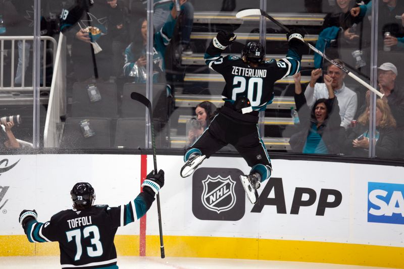 Oct 12, 2024; San Jose, California, USA; San Jose Sharks left winger Fabian Zetterlund (20) celebrates his apparent goal against the Anaheim Ducks on a fast break during the first period at SAP Center at San Jose. Referees conferred and ruled that Zetterlund had been offsides. Mandatory Credit: D. Ross Cameron-Imagn Images