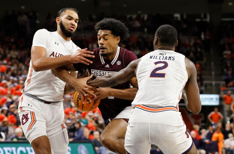 Jan 14, 2023; Auburn, Alabama, USA;  Auburn Tigers forwards Johni Broome (4) and Auburn Jaylin Williams (2) strip the ball from Mississippi State Bulldogs forward Tolu Smith (1) during the first half at Neville Arena. Mandatory Credit: John Reed-USA TODAY Sports