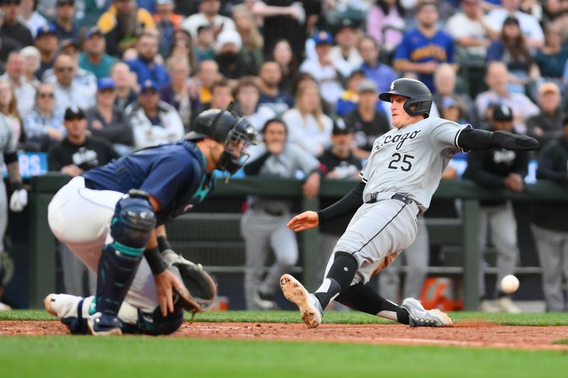 Jun 10, 2024; Seattle, Washington, USA; Chicago White Sox first baseman Andrew Vaughn (25) slides into home plate to score a run against the Seattle Mariners during the seventh inning at T-Mobile Park. Mandatory Credit: Steven Bisig-USA TODAY Sports