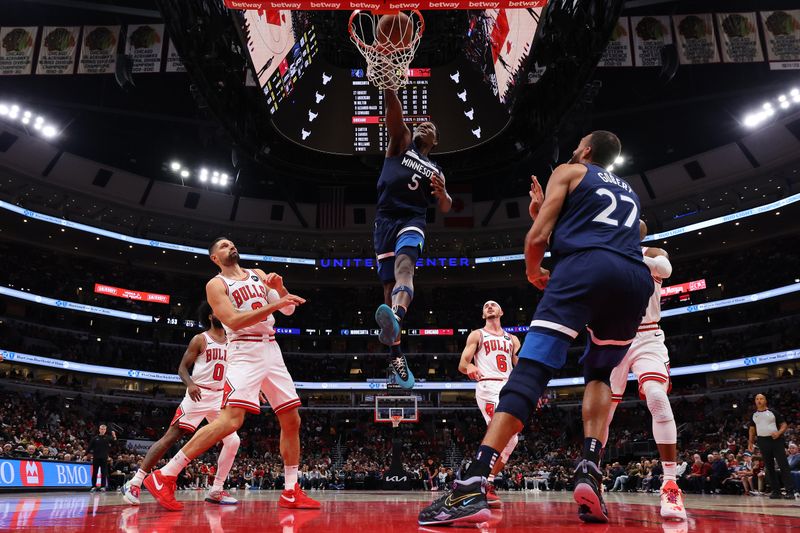 CHICAGO, ILLINOIS - OCTOBER 19: Anthony Edwards #5 of the Minnesota Timberwolves dunks against the Chicago Bulls during the first half of a preseason game at the United Center on October 19, 2023 in Chicago, Illinois. NOTE TO USER: User expressly acknowledges and agrees that, by downloading and or using this photograph, User is consenting to the terms and conditions of the Getty Images License Agreement.  (Photo by Michael Reaves/Getty Images)