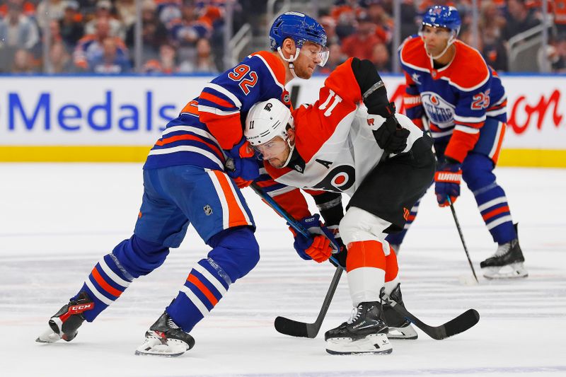 Oct 15, 2024; Edmonton, Alberta, CAN; Edmonton Oilers forward Vasily Podkolzin (92) and Philadelphia Flyers forward Travis Konecny (11) battle for position  during the third period at Rogers Place. Mandatory Credit: Perry Nelson-Imagn Images