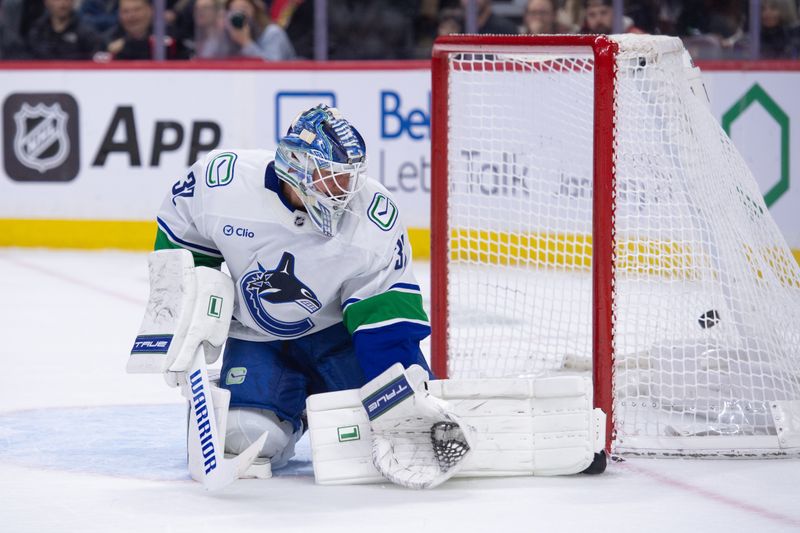 Jan 13, 2026; Ottawa, Ontario, CAN; Vancouver Canucks goalie Kevin Lankinen (32) is unable to stop a shot from Ottawa Senators defenseman Artem Zub (not pictured) in the first period at the Canadian Tire Centre. Mandatory Credit: Marc DesRosiers-IMAGN Images