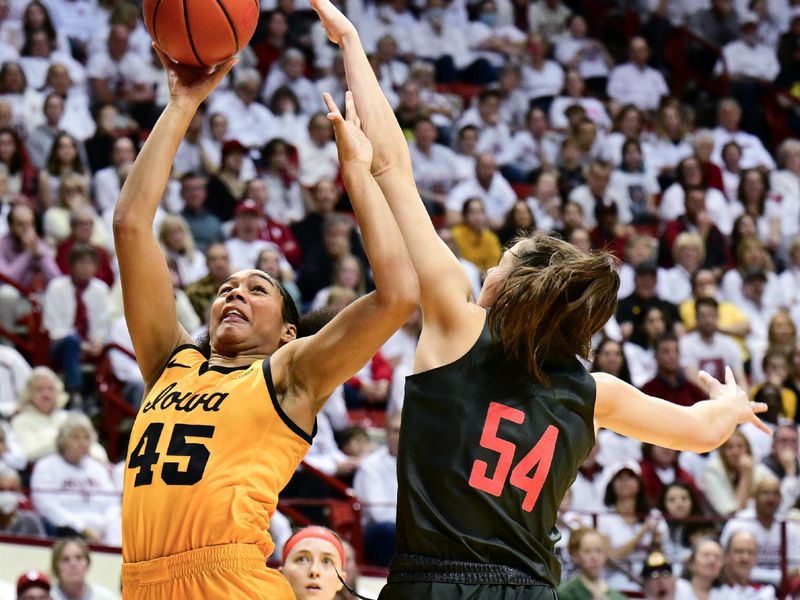 Feb 22, 2024; Bloomington, Indiana, USA; Iowa Hawkeyes forward Hannah Stuelke (45) shoots the ball against Indiana Hoosiers forward Mackenzie Holmes (54) during the first quarter at Simon Skjodt Assembly Hall. Mandatory Credit: Marc Lebryk-USA TODAY Sports